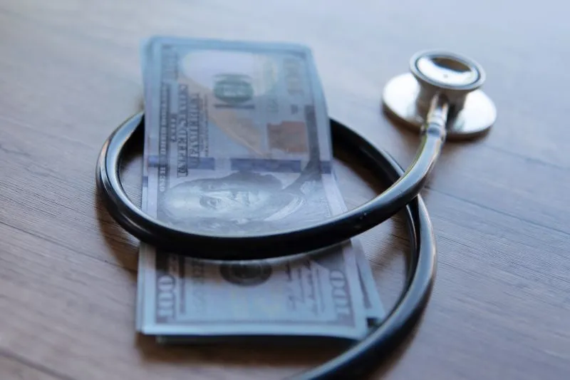 Stethoscope on U.S. currency, representing Affordable Care Act health insurance costs and subsidies
